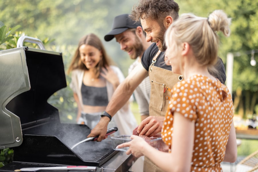 Group of friends using a grill at 805 Riverfront