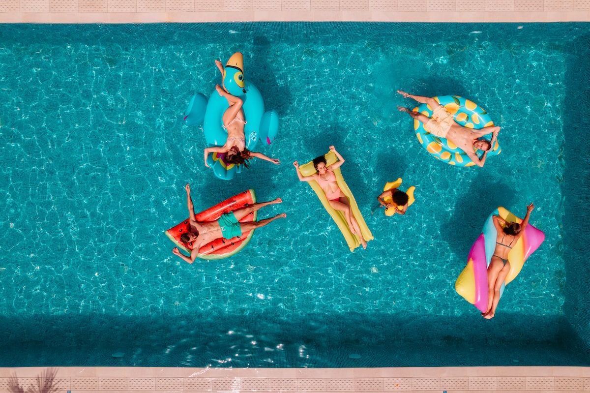 Group of friends floating in the pool at 805 Riverfront