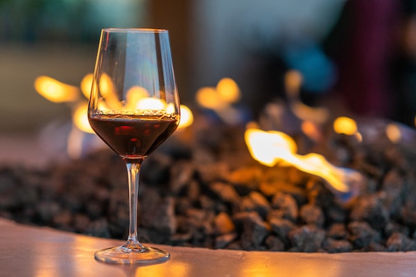 Residents drinking wine around the fire at 805 Riverfront