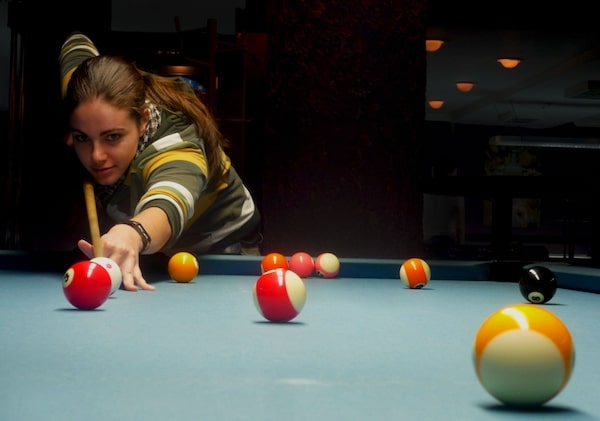 805 Riverfront resident playing pool in the Resident Lounge